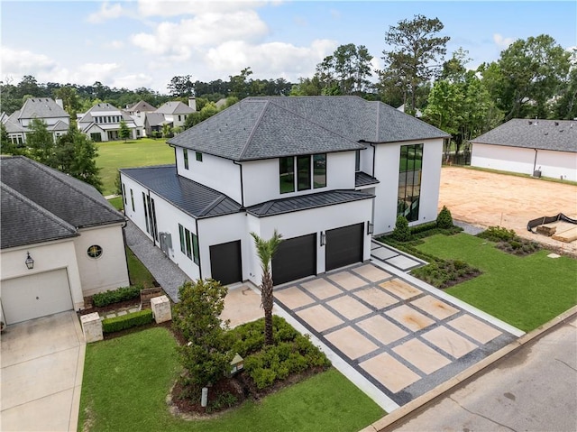 67 Hummingbird Rd, Covington, LA 70433 - view of front of home with driveway, a standing seam roof, stucco siding, a shingled roof, and an attached garage