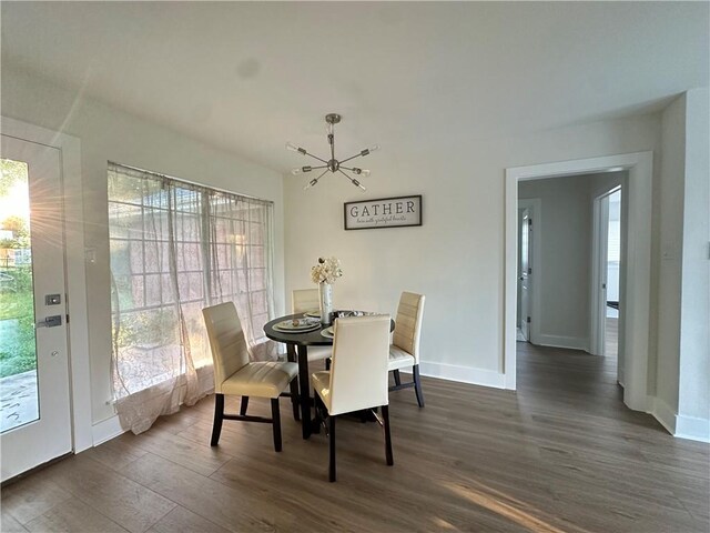 839 Behrman Ave, New Orleans, LA 70114 - dining space with dark wood-style floors, a chandelier, and baseboards
