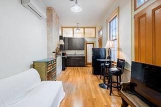 1700 S Rampart St, New Orleans, LA 70113 - living area with a wall unit AC and light wood-type flooring