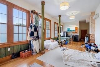 1700 S Rampart St, New Orleans, LA 70113 - bedroom featuring decorative columns and wood finished floors