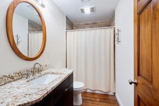 1700 S Rampart St, New Orleans, LA 70113 - bathroom featuring vanity, wood finished floors, toilet, and a shower with curtain