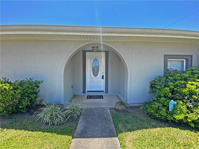doorway to property with stucco siding