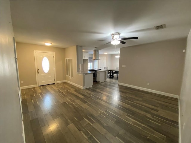entryway with a ceiling fan, baseboards, dark wood-style floors, and plenty of natural light