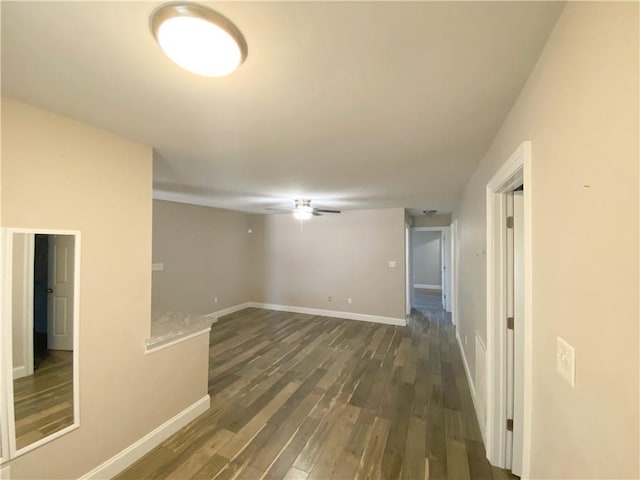 empty room with wood finished floors, baseboards, and ceiling fan