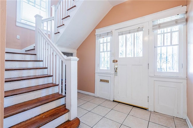 2315 Peniston St, New Orleans, LA 70115 - foyer entrance with light tile patterned floors, stairway, lofted ceiling, and baseboards