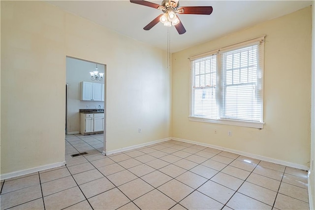 2315 Peniston St, New Orleans, LA 70115 - unfurnished room featuring light tile patterned floors, ceiling fan, a chandelier, and baseboards