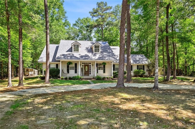 20035 River Parc Dr, Covington, LA 70433 - new england style home with a porch and view of wooded area