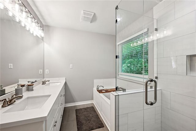 20035 River Parc Dr, Covington, LA 70433 - bathroom featuring a shower stall, a garden tub, double vanity, baseboards, and tile patterned floors