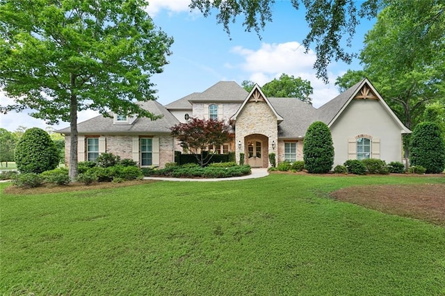 474 Trailhead Dr, Abita Springs, LA 70420 - french country style house featuring a front yard and stone siding