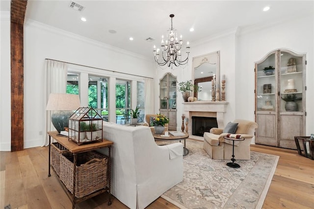 474 Trailhead Dr, Abita Springs, LA 70420 - living room with ornamental molding, light wood finished floors, a fireplace, a chandelier, and recessed lighting