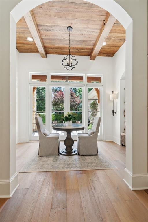 474 Trailhead Dr, Abita Springs, LA 70420 - dining area with wooden ceiling with exposed beams, baseboards, hardwood / wood-style flooring, arched walkways, and a chandelier