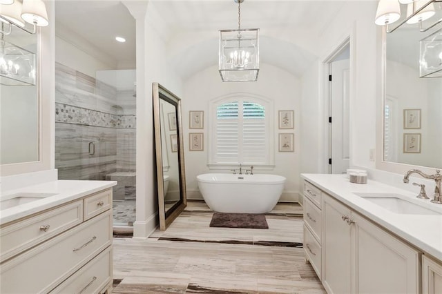 474 Trailhead Dr, Abita Springs, LA 70420 - full bath with a chandelier, a shower stall, two vanities, a freestanding bath, and recessed lighting