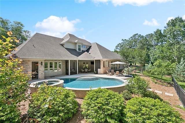 474 Trailhead Dr, Abita Springs, LA 70420 - view of pool featuring a patio area, a fenced backyard, french doors, and a pool with connected hot tub