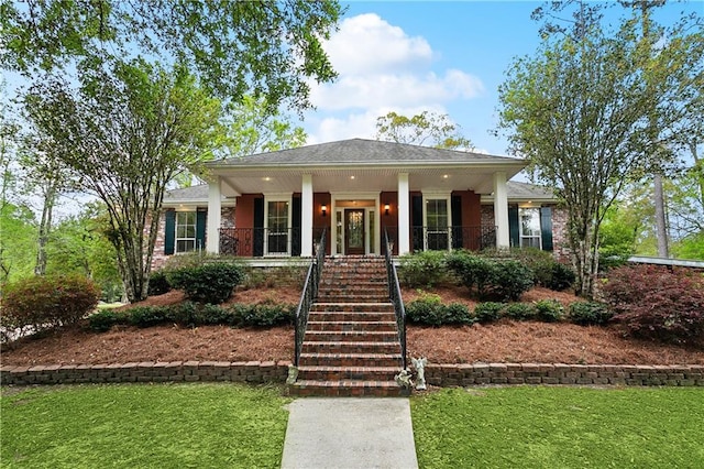 740 Double J Rd, Covington, LA 70433 - view of front of home with stairway, a porch, and a front yard