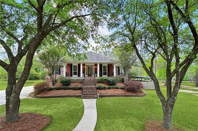 740 Double J Rd, Covington, LA 70433 - single story home with stairway, a front lawn, a porch, and driveway