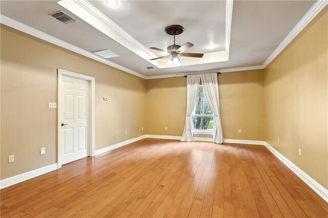 740 Double J Rd, Covington, LA 70433 - unfurnished room with a tray ceiling, ceiling fan, light wood-style flooring, and ornamental molding