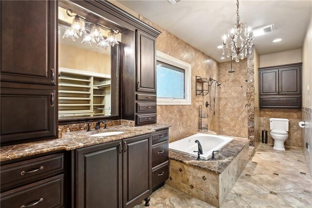 740 Double J Rd, Covington, LA 70433 - bathroom with a chandelier, tiled bath, tiled shower, vanity, and tile walls