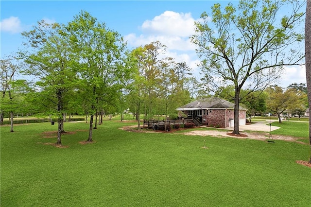 740 Double J Rd, Covington, LA 70433 - view of green lawn with driveway and a deck