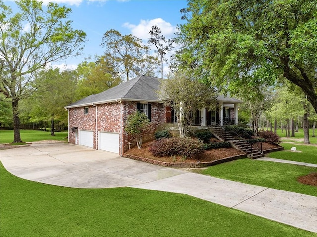 740 Double J Rd, Covington, LA 70433 - ranch-style home with stairs, brick siding, concrete driveway, an attached garage, and a front lawn