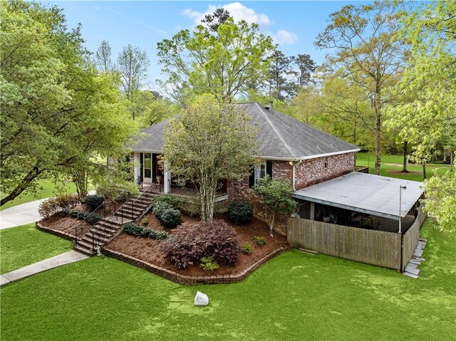 740 Double J Rd, Covington, LA 70433 - back of property with stairway, a lawn, and roof with shingles