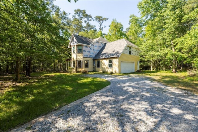 116 Fay Way, Slidell, LA 70460 - view of front of house with gravel driveway, a front yard, and an attached garage