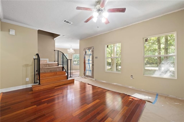 116 Fay Way, Slidell, LA 70460 - unfurnished living room featuring wood-type flooring, a chandelier, plenty of natural light, crown molding, and a textured ceiling