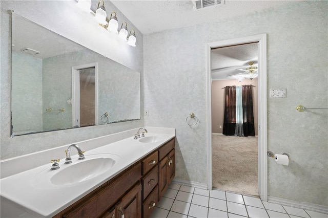 116 Fay Way, Slidell, LA 70460 - full bathroom with a textured ceiling, tile patterned floors, baseboards, double vanity, and ceiling fan