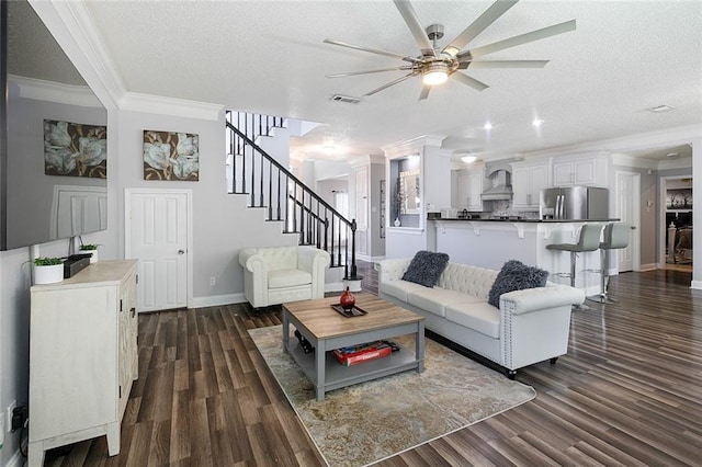 1332 Denmark Ct, Slidell, LA 70461 - living room featuring crown molding, ceiling fan, a textured ceiling, baseboards, and stairway
