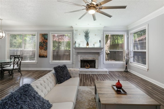 1332 Denmark Ct, Slidell, LA 70461 - living area with baseboards, a fireplace with raised hearth, ornamental molding, a textured ceiling, and plenty of natural light