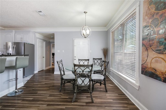 1332 Denmark Ct, Slidell, LA 70461 - dining area featuring dark wood-style floors, baseboards, a chandelier, and ornamental molding