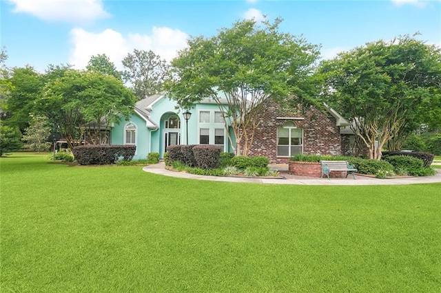 1203 W Cherry Hill Loop, Folsom, LA 70437 - obstructed view of property with a front lawn and stucco siding