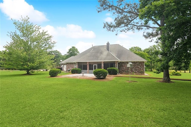 1203 W Cherry Hill Loop, Folsom, LA 70437 - back of property with a yard, a chimney, brick siding, and a patio area