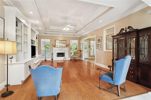 1203 W Cherry Hill Loop, Folsom, LA 70437 - living area featuring ceiling fan, a fireplace, a raised ceiling, ornamental molding, and light wood-style floors