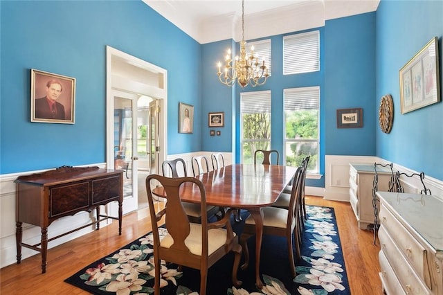 1203 W Cherry Hill Loop, Folsom, LA 70437 - dining area featuring a chandelier, light wood-type flooring, wainscoting, and a high ceiling