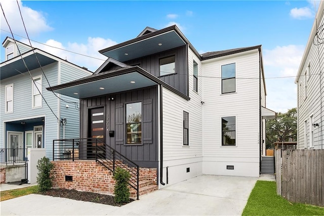 172224 St Ann St, New Orleans, LA 70116 - view of front of property featuring crawl space, board and batten siding, and fence