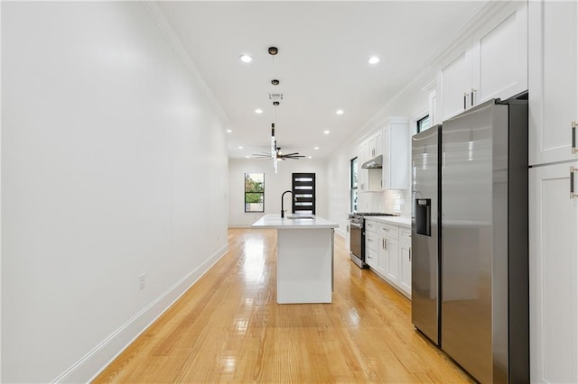 172224 St Ann St, New Orleans, LA 70116 - kitchen featuring appliances with stainless steel finishes, a sink, white cabinetry, light countertops, and a kitchen island with sink