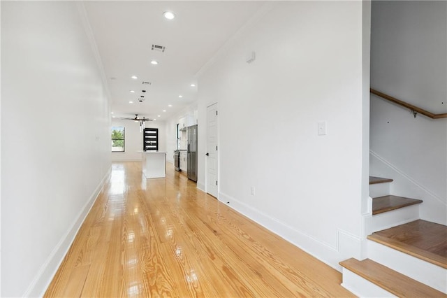 172224 St Ann St, New Orleans, LA 70116 - hallway with stairs, recessed lighting, baseboards, light wood-style floors, and crown molding