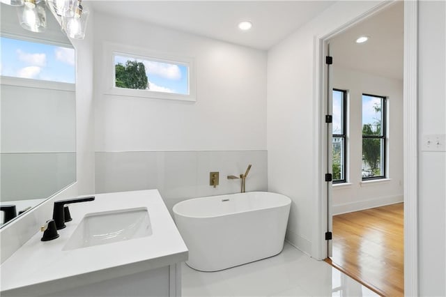 172224 St Ann St, New Orleans, LA 70116 - bathroom with healthy amount of natural light, a freestanding tub, vanity, tile patterned floors, and recessed lighting