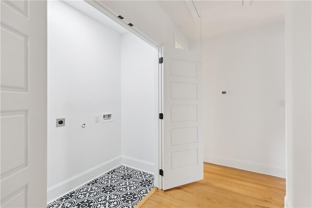 172224 St Ann St, New Orleans, LA 70116 - laundry room featuring electric dryer hookup, baseboards, washer hookup, light wood-type flooring, and attic access