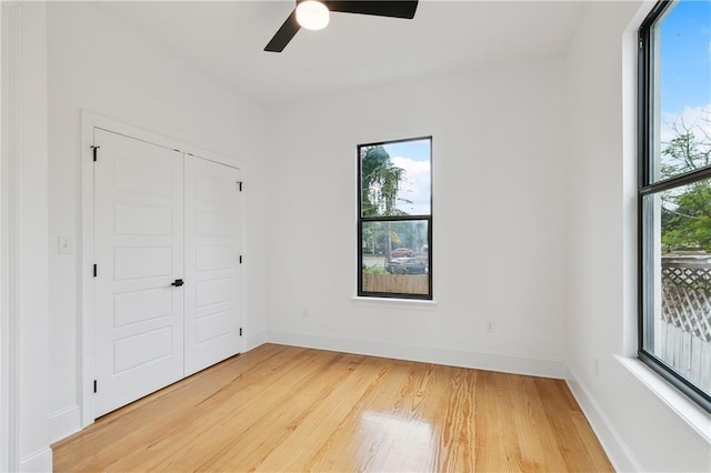 172224 St Ann St, New Orleans, LA 70116 - unfurnished bedroom featuring light wood-style floors, baseboards, a closet, and a ceiling fan