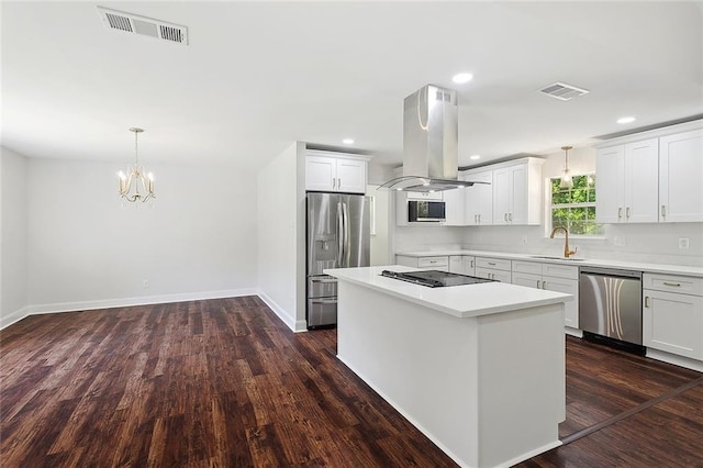 113 Roger Storme Rd, Madisonville, LA 70447 - kitchen with appliances with stainless steel finishes, island exhaust hood, a sink, a center island, and light countertops