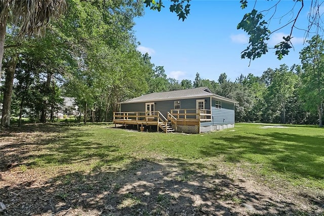 113 Roger Storme Rd, Madisonville, LA 70447 - back of property featuring a yard and a wooden deck