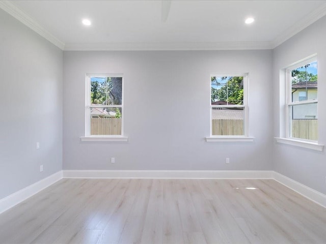 empty room with light wood-type flooring, crown molding, baseboards, and recessed lighting