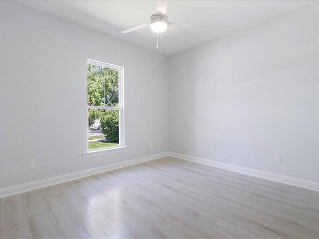 unfurnished room featuring light wood finished floors, ceiling fan, and baseboards