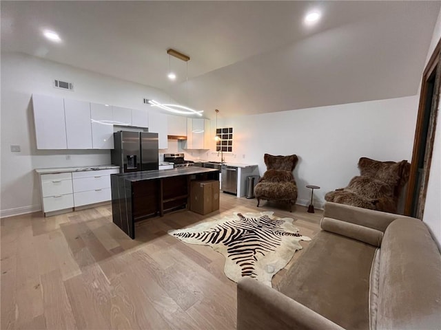 1819 Baronne St, New Orleans, LA 70113 - kitchen featuring appliances with stainless steel finishes, modern cabinets, a kitchen island, white cabinets, and open floor plan