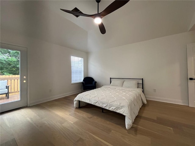 1819 Baronne St, New Orleans, LA 70113 - bedroom featuring access to exterior, wood finished floors, multiple windows, and high vaulted ceiling