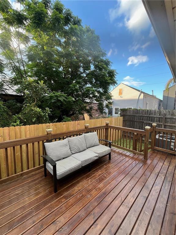 1819 Baronne St, New Orleans, LA 70113 - wooden terrace with a fenced backyard and an outdoor living space