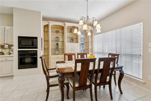 3 Lake Lynn Dr, Harvey, LA 70058 - dining area with a chandelier, baseboards, a textured ceiling, and light tile patterned floors