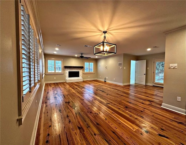 726 S Massachusetts St, Covington, LA 70433 - unfurnished living room featuring dark wood-style floors, baseboards, a chandelier, recessed lighting, and ceiling fan