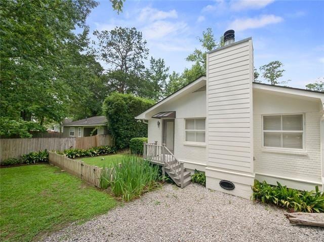 726 S Massachusetts St, Covington, LA 70433 - view of side of property with a chimney